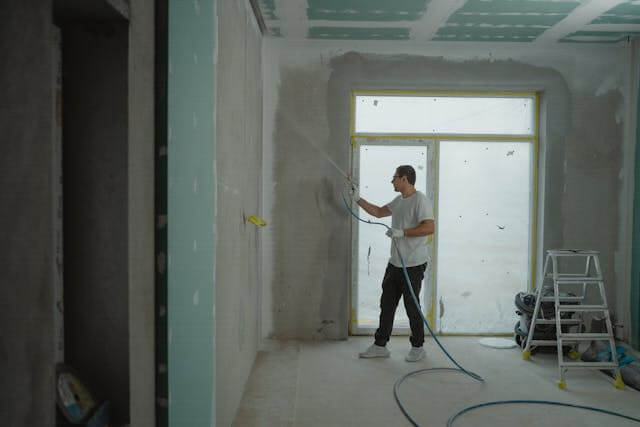 Interior painting contractor rolling paint on walls in Lake Illawarra home
